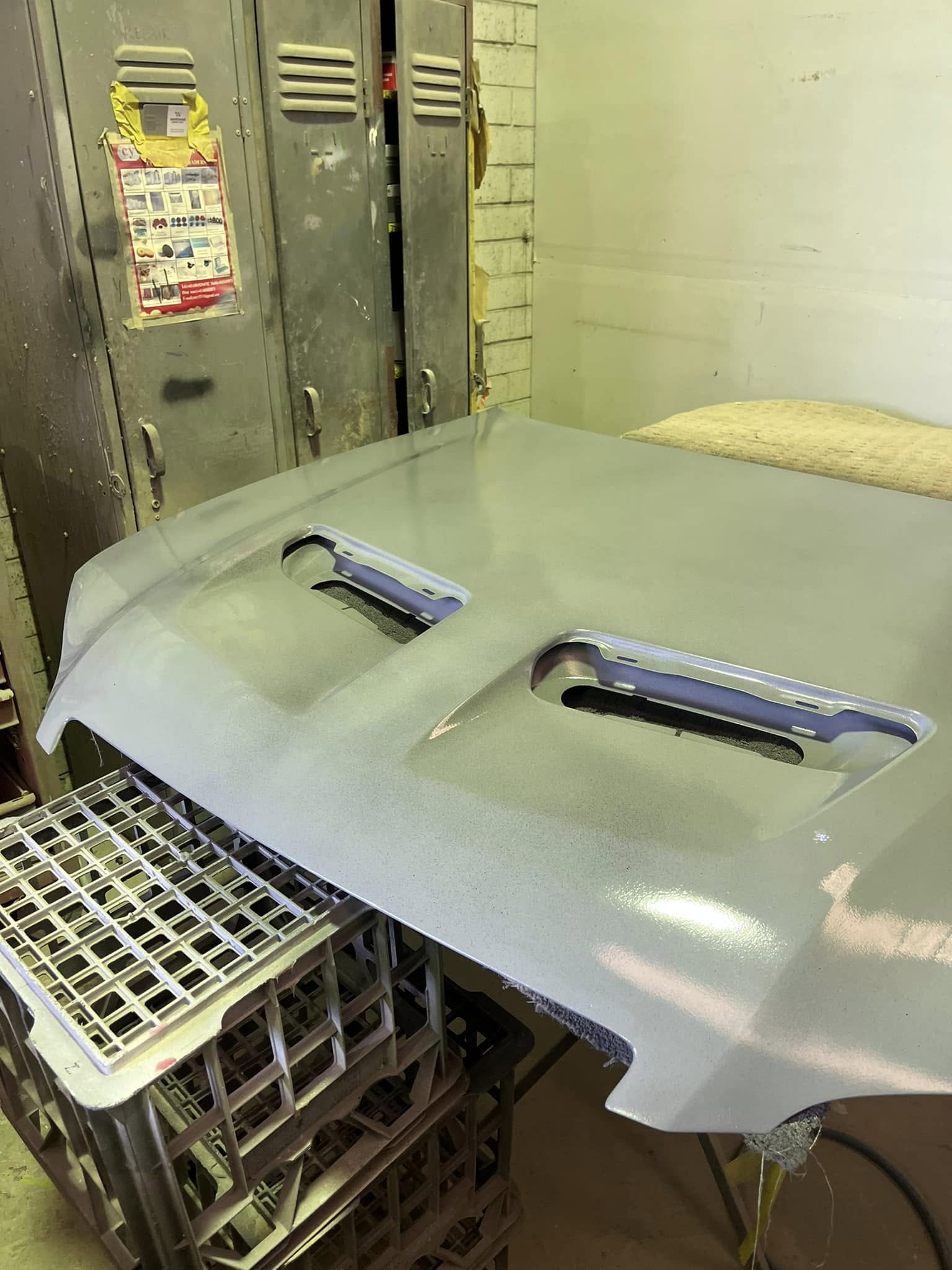 Bonnet with twin vents sitting on crates after a paint finish