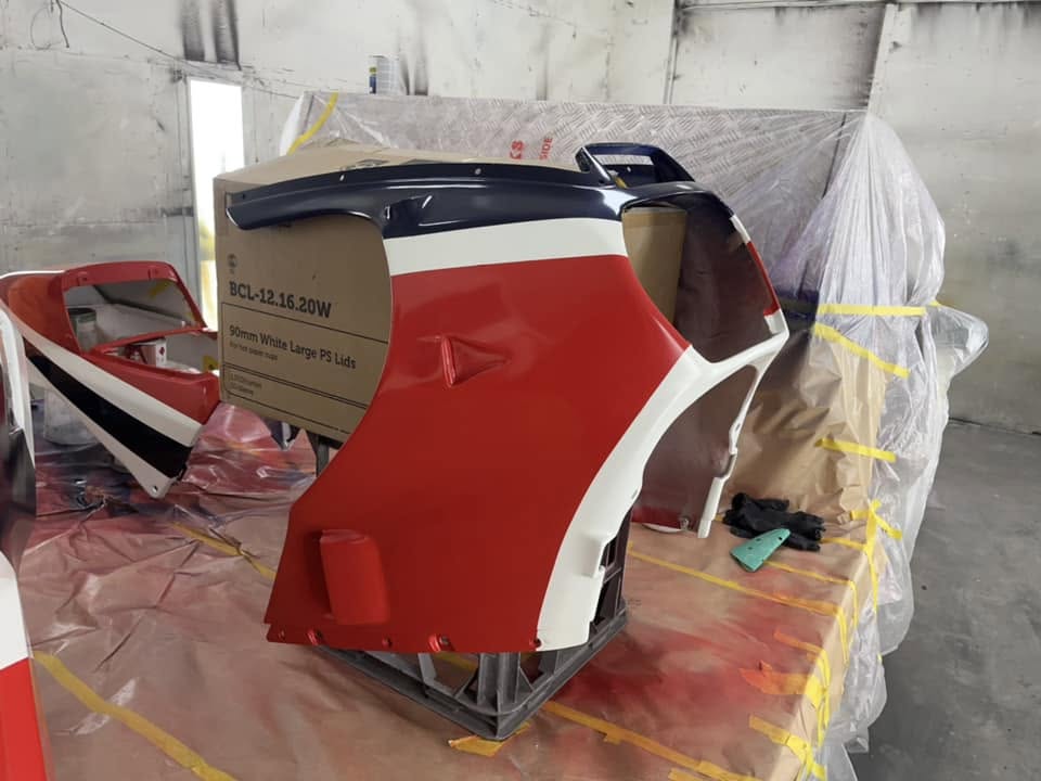 Red, white and navy painted panels on a workshop stand